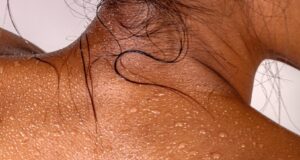 the back of a woman's head with white spots on it