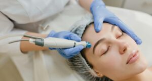 a woman getting a facial peel from a doctor