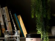 a glass of water next to a jar of balance and mood support