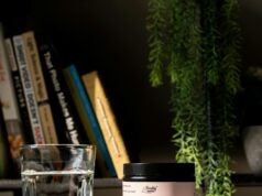 a glass of water next to a jar of balance and mood support